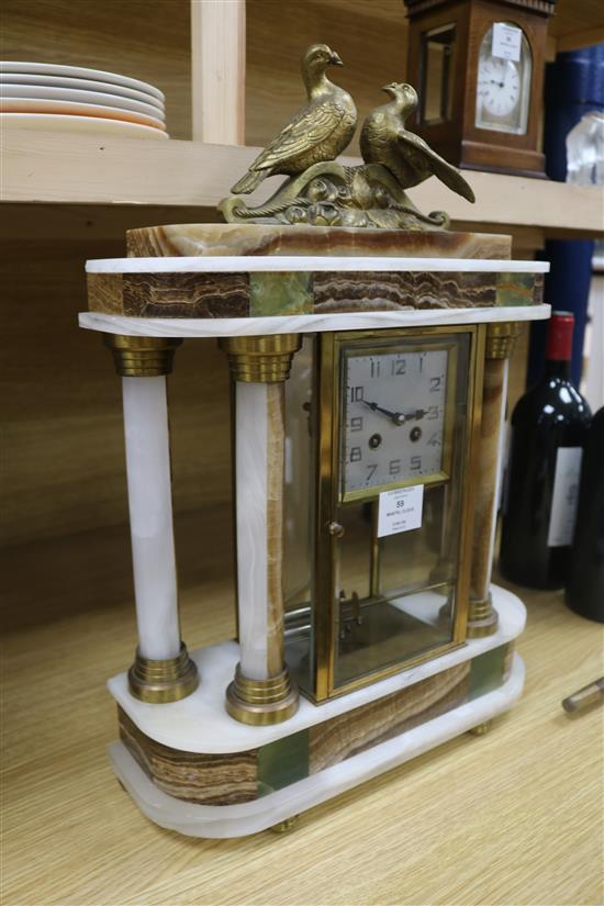 A 1930s polychrome onyx portico mantel clock, height 53cm